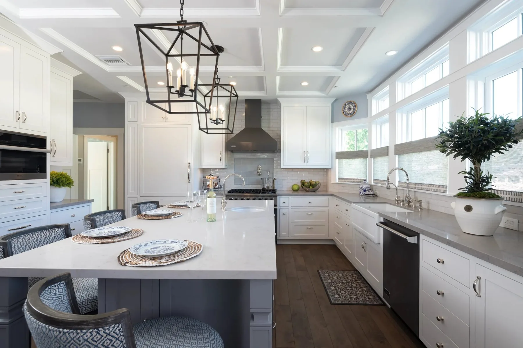 Bright white kitchen remodel by DSC with coffered ceiling and lantern pendants