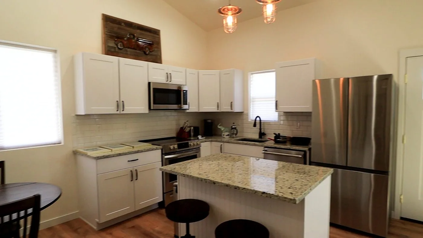 The Wave House kitchen with white shaker cabinets and island